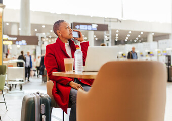 a woman drinking coffee at the airport