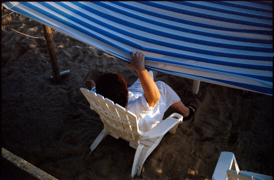 Woman is resting under the windbreak