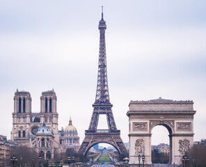 Iconic Paris landmarks collage: Eiffel Tower, Notre Dame Cathedral, and Arc de Triomphe, against an overcast sky, showcasing grand architecture.