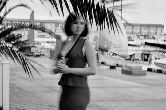 Motion blur shot of a woman holding clear umbrella
