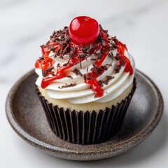 A delicious cupcake topped with frosting, chocolate shavings, and a cherry, a treat on a plate.  side view, solid background
