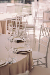 Elegant dining setup for a special event in a bright, airy venue with soft colors and beautiful tableware