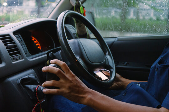 Driver Navigating a Vehicle Through Rainy Weather