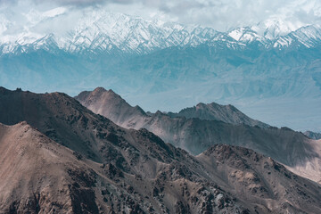 Majestic snow-capped Himalayan mountains near Leh under clear blue sky, showcasing stunning natural landscape, winter wilderness, breathtaking panoramic view of rugged peaks scenic tranquility