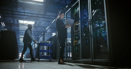 Wide view of technician working in data center.