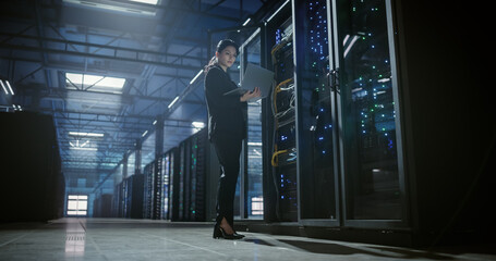 Wide view of technician working in data center.