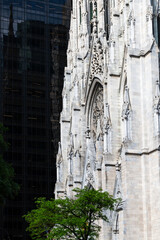 Close-up of St. Patrick’s Cathedral in New York City, showcasing its neo-Gothic architecture amid the modern skyscrapers of Midtown Manhattan. 