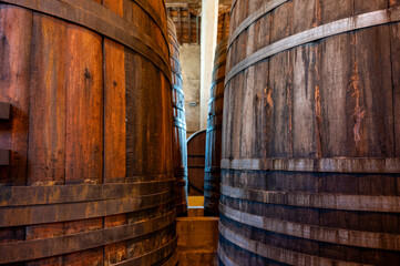 Old oak barrels for aging of natural sweet red grand cru wine Banyuls fortified dessert wine from...