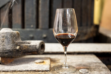 Tasting of Banyuls AOC aged natural sweet grand cru Banyuls fortified dessert wine from old vines from slopes Pyrenees in Roussillon, France made in glass jar Dame Jeanne or demijohn