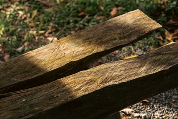 Rustic outdoor seating area with vintage wooden tables and benches under natural light, showcasing the charm of aged wood craftsmanship, peaceful atmosphere, sustainable design, eco-friendly lifestyle