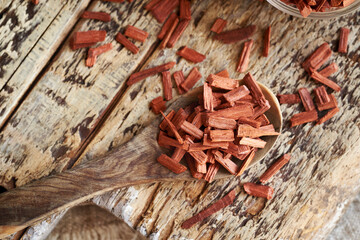 Red sandalwood chips on a wooden spoon, close up