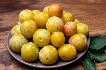 Sweet ripe small yellow mirabelle plums, healthy organic fruits close up
