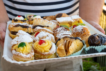 Italian sweet dessert dolce pastry and cakes with cream and fruits on plate made in artisanal bakery in Rome, Italy, close up