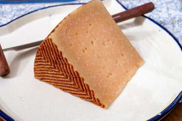 Very old anejo tostado Spanish hard cheese, cow and sheep curado, manchego, goat cheese close up