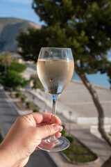 Celebration, birthday party, pouring of white wine made from grillo grapes on holiday on Mondello beach, Palermo, Sicily, Italy