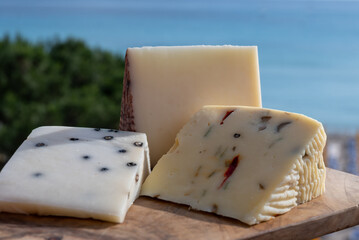 Italian provolone cheese made with fresh rocket salad, black pepper, olives, wine, Sicilian cheese, Palermo food and sea view on Mondello beach nea Palermo, Sicily