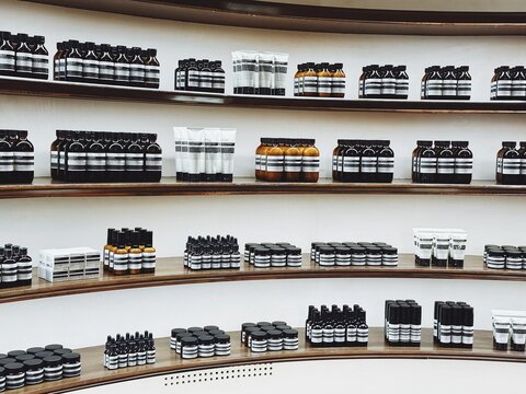 29.05.2025, Kuala Lumpur, Malaysia.Neatly arranged shelves with bottles, jars, and tubes of skincare products in Aesop store. Minimalist design with white and black labels.