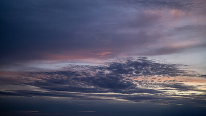 Colorful sunset with dramatic clouds over the horizon. A breathtaking evening sky filled with warm light.