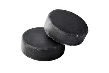 Two black hockey pucks stacked and isolated on a seamless dark surface