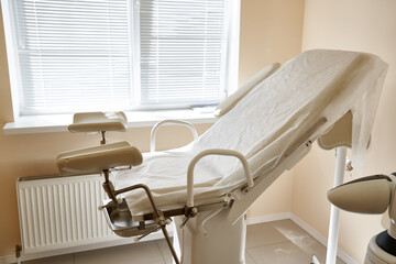 Gynecological chair in the clinic. gynecology room, medical instruments, interior of the genicology clinic