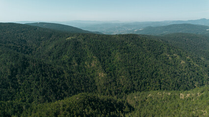 Obraz premium Aerial view of green mountain ridges and forested valleys in Divcibare, Serbia