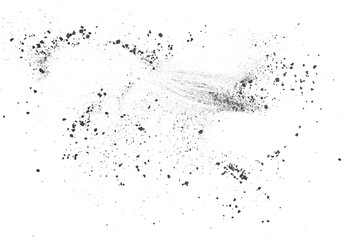 Particles of black charcoal on a white background, top view. Abstract powder splatted background. Black powder exploding.
