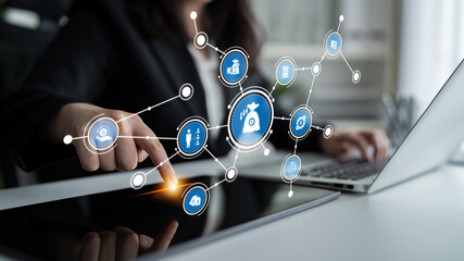 A businesswoman interacts with a digital interface, showcasing virtual connectivity and data...