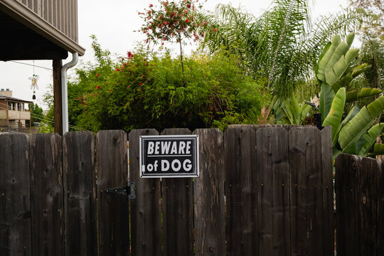 "Beware of Dog" Sign on Wooden Gate