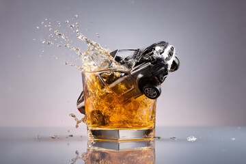 Powerful social advertising against drunk driving, a crashed car falls into a glass of whiskey, a surreal concept, photo for a poster