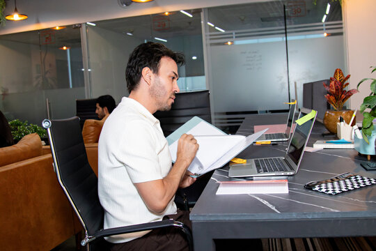 Medium shot of an office employee focused on a marketing project