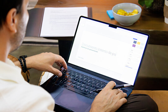 Office employee seated in a coworking lounge working on a project