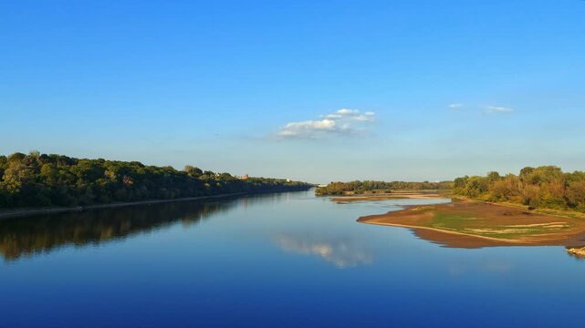 High angle view of a confluence of Narew (left) and Vistula (right) rivers with lush green banks.