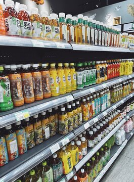 29.05.2025, Kuala Lumpur, Malaysia.Rows of bottled tea drinks in different flavors on supermarket shelves. Colorful plastic bottles with white caps, Asian drink brands.
