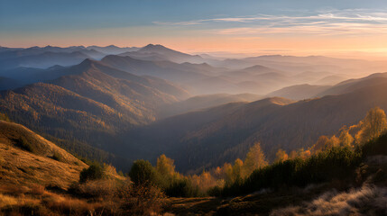 Obraz premium Majestic mountain landscape at sunset, showcasing rolling hills, vibrant autumn foliage, and misty valleys, creating a serene and tranquil natural environment for outdoor enthusiasts