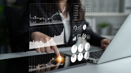 A businesswoman conducts a detailed analysis of financial data on her laptop, interacting with dynamic graphs and charts in a sleek office environment. Impute