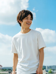Asian young male mockup model wearing white plain T-shirt on a sunny day, outdoor fashion template
