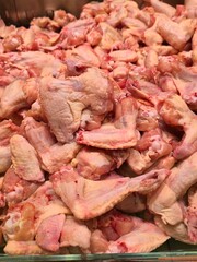 a large pile of fresh raw chicken wings for sale