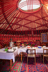 Table set up for dinner inside a traditional yurt in Kyrgyzstan, central Asia.