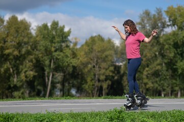 Caucasian woman roller skating in park. 
