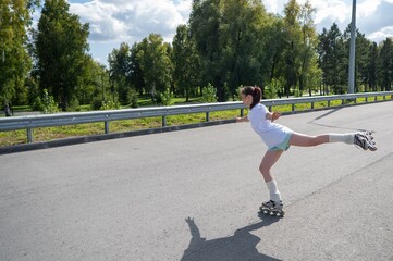Caucasian woman in shorts roller skating. 