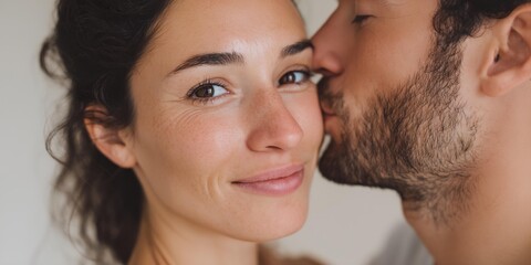 Fototapeta premium Man kisses a woman's face