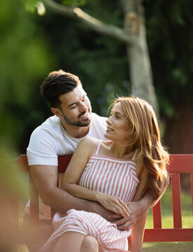 Girlfriend receiving backhug from handsome boyfriend