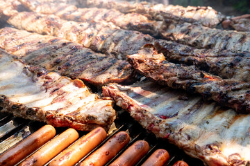 A close up of delicious pork ribs and sausages on a barbecue grill The Ultimate Summer Celebration