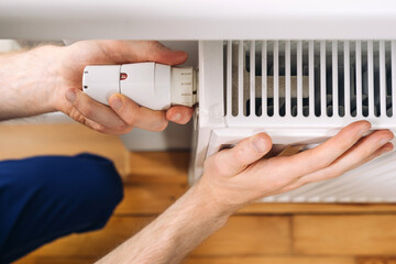 Home heating radiator maintenance with a plumber installing a new component