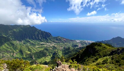 Fototapeta premium Panoramic mountain vista over lush valleys and ocean