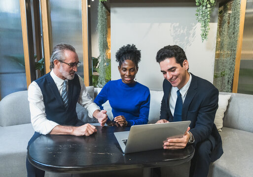 business meeting discussion among people seat around table modern office laptop on table convey collaboration communication relax working environment making suitable content related team office life.
