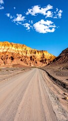 Desert road winding through colorful mountains