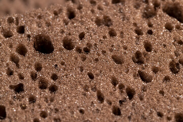 a synthetic sponge with lots of holes for good foaming of detergents and is used for cleaning