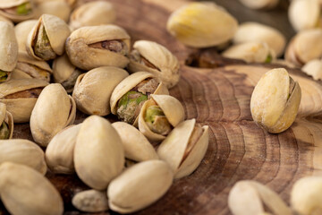 scattered salted pistachios after roasting with cracked shells, close up