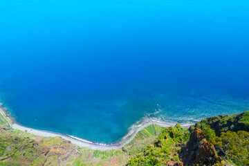 Experience breathtaking views from Cabo Girao Skywalk over the stunning coastline of Madeira, Portugal with its rich blue waters and lush landscapes